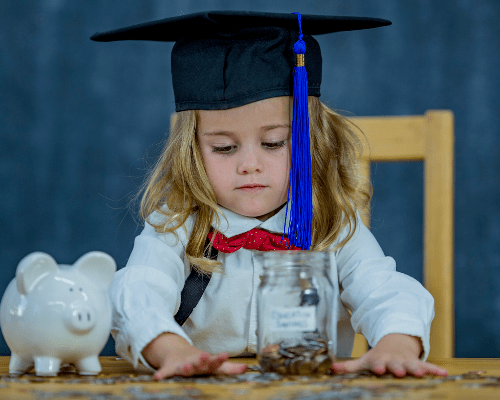 Toddler wearing a graduation cap and counting money for piggy bank. About Education Planning Concept.