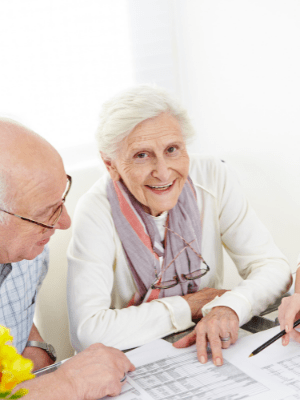 Smiling senior couple going over financial documents. About Tax Planning Concept.