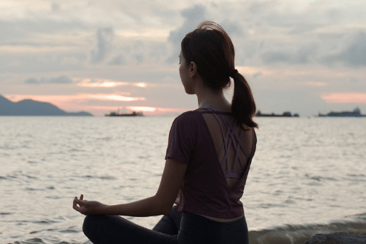 Woman Does Yoga at the Beach. Visualizes the first element of the Netvesco tagline: Dream