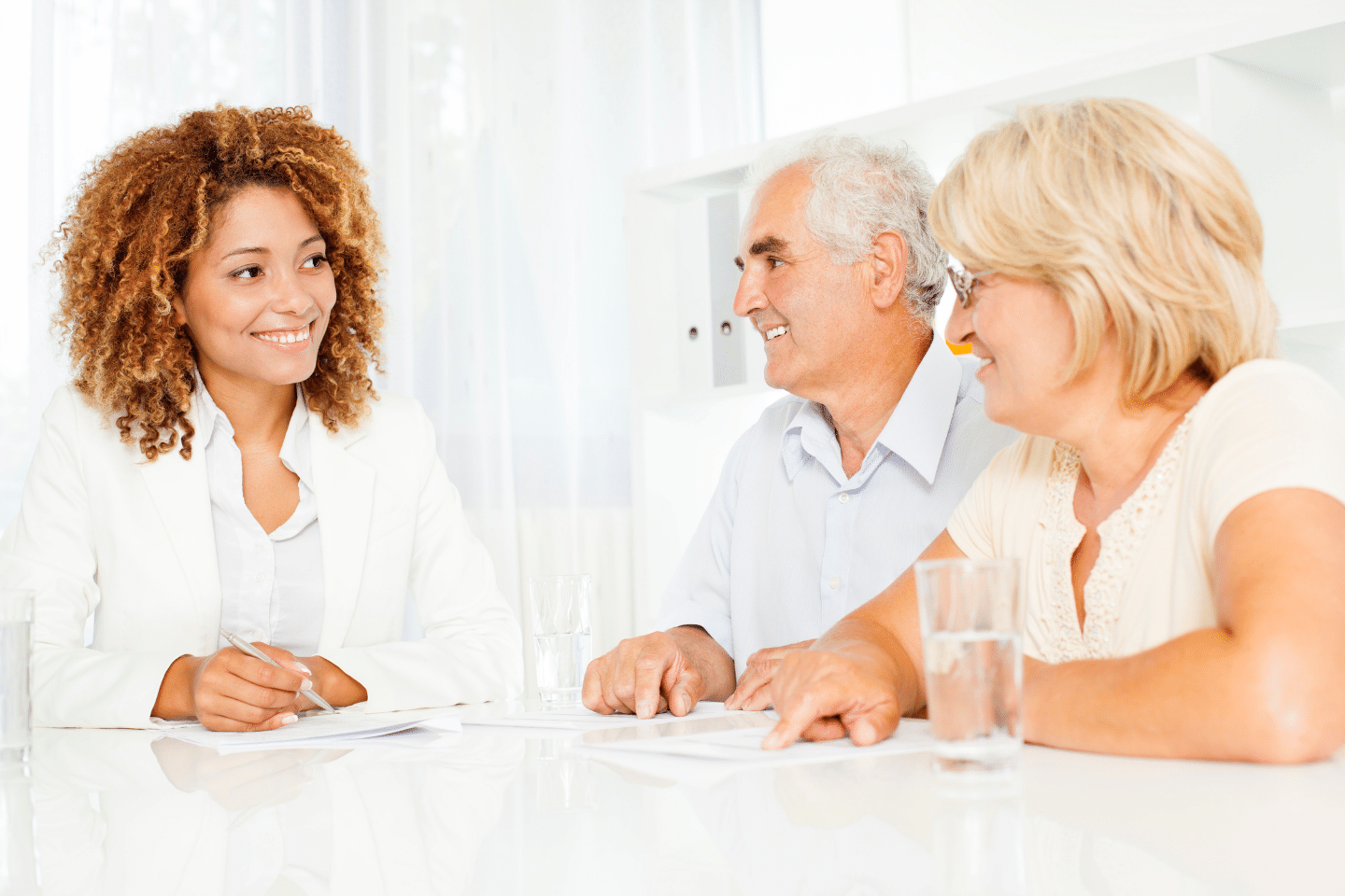 Senior couple meeting with financial advisor and providing information about their current economic situation and future financial goals. Comprehensive financial planning concept.