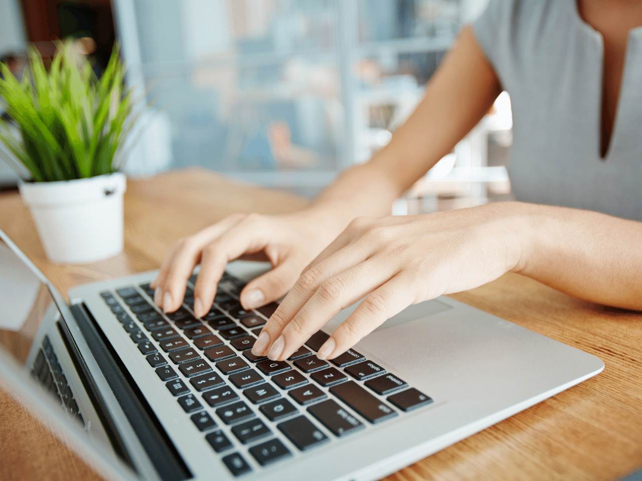 Inputting information: Closeup of female hands typing on laptop. Preparing for the initial financial planning appointment by completing a questionnaire.