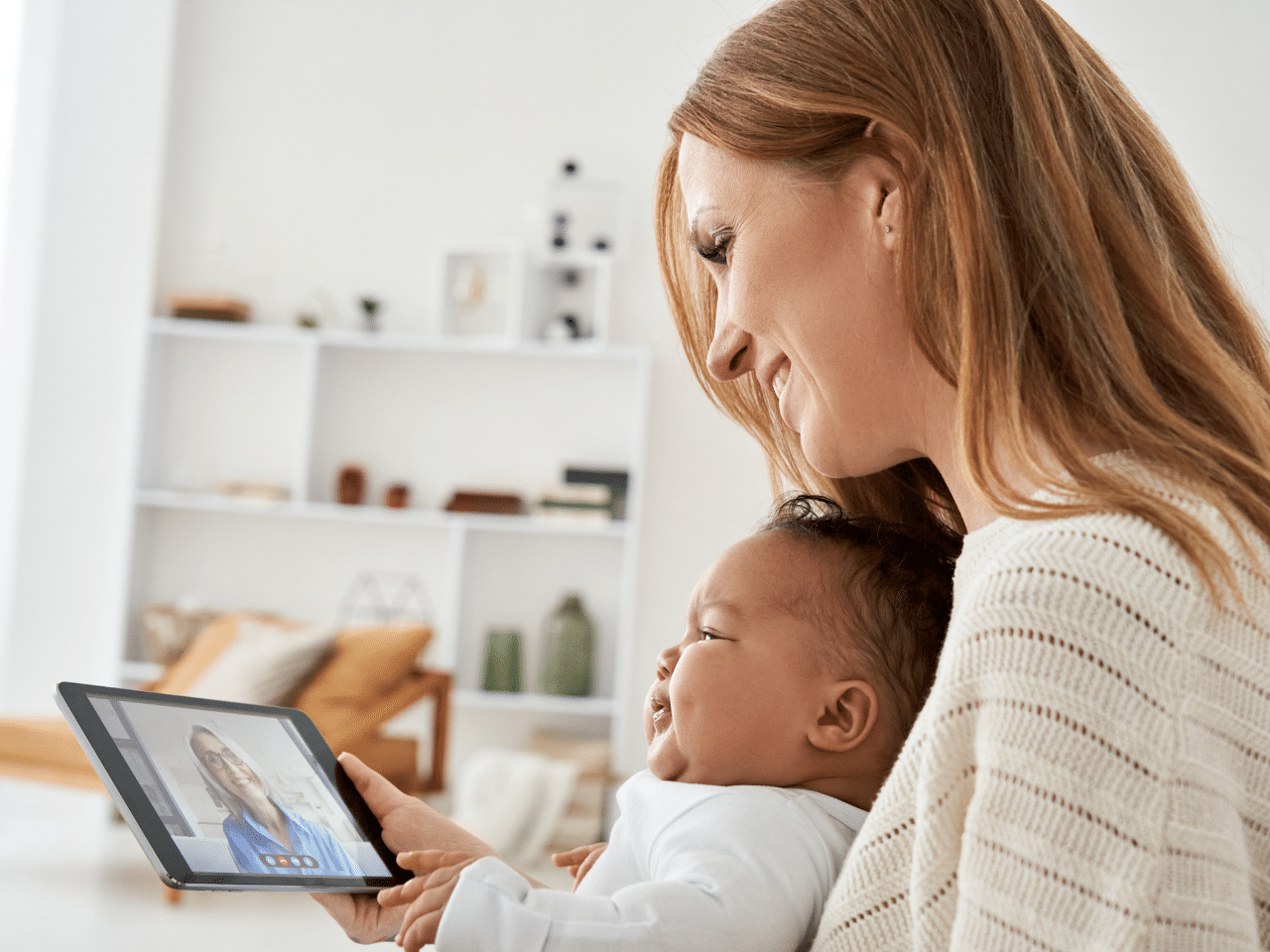 Caucasian Mother Holding Crying African Baby Having Meeting Video Call at Home. Appointment Concept.