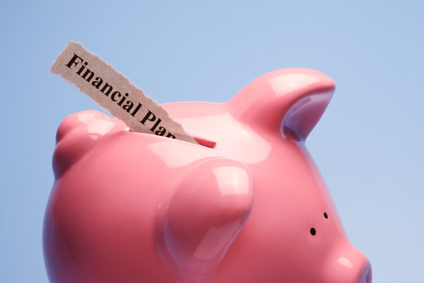 Personal Financial Planning: Piggy bank against blue background