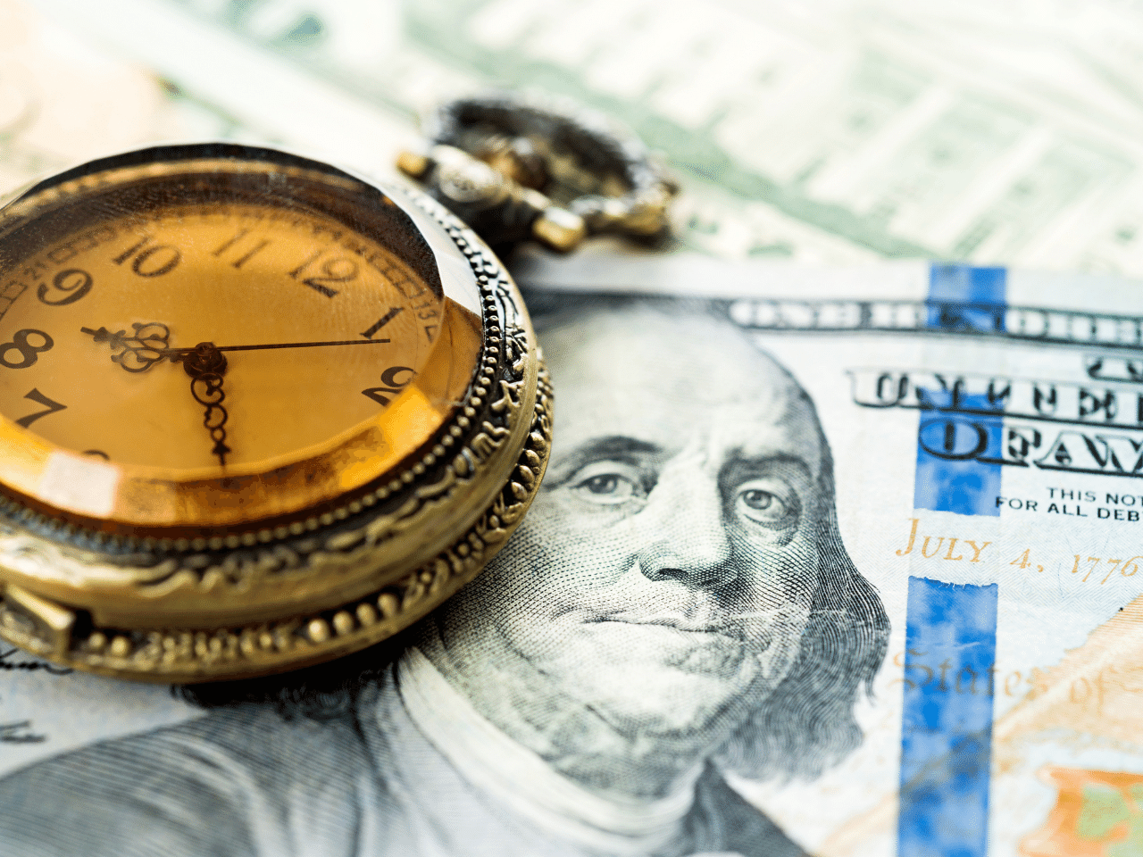 Time and Money: Hundred dollar bills and gold stopwatch.