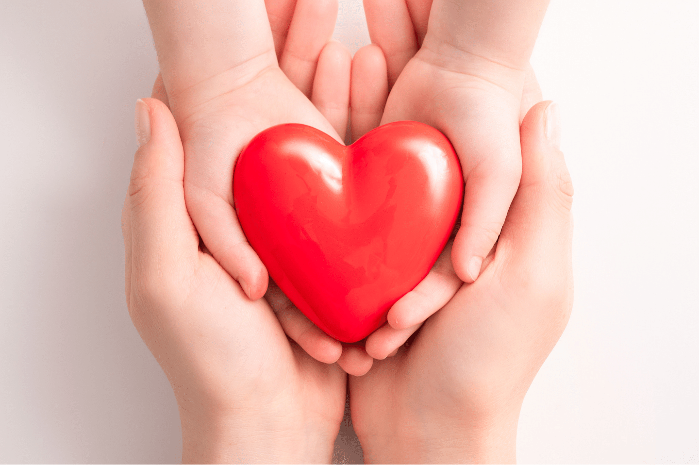 Closeup of woman and child holding heart. Charitable giving concept.