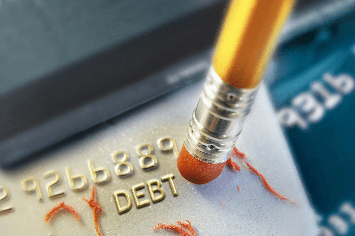 Pencil erasing credit card debt. Debt Reduction Concept