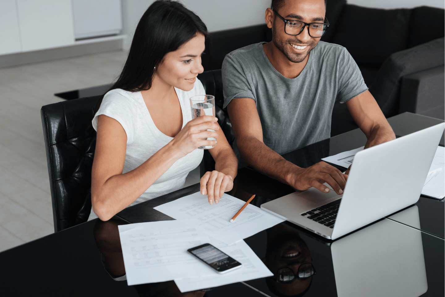 Loving Young Couple Using Laptop and Analyzing Their Finances. Investing Concept