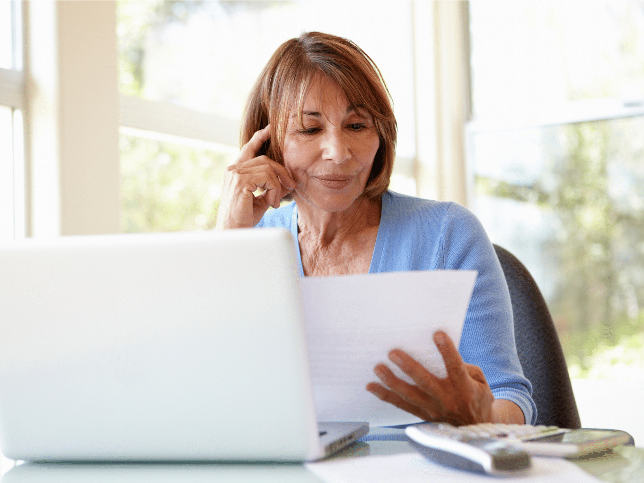 Senior Hispanic woman working on laptop. Subscribe Concept.