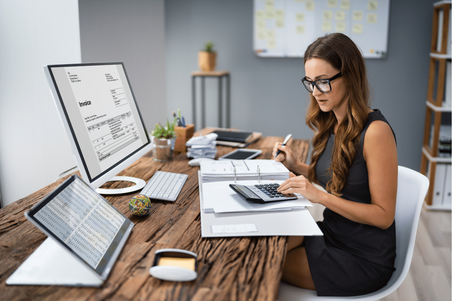 Woman calculating invoice at workplace. Tax Break Concept